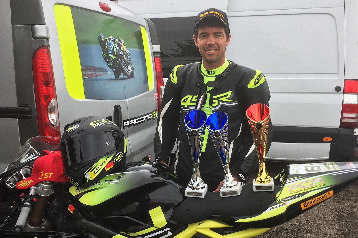 Chris Lavisher with trophies won for C and J Motorcycle Racing
